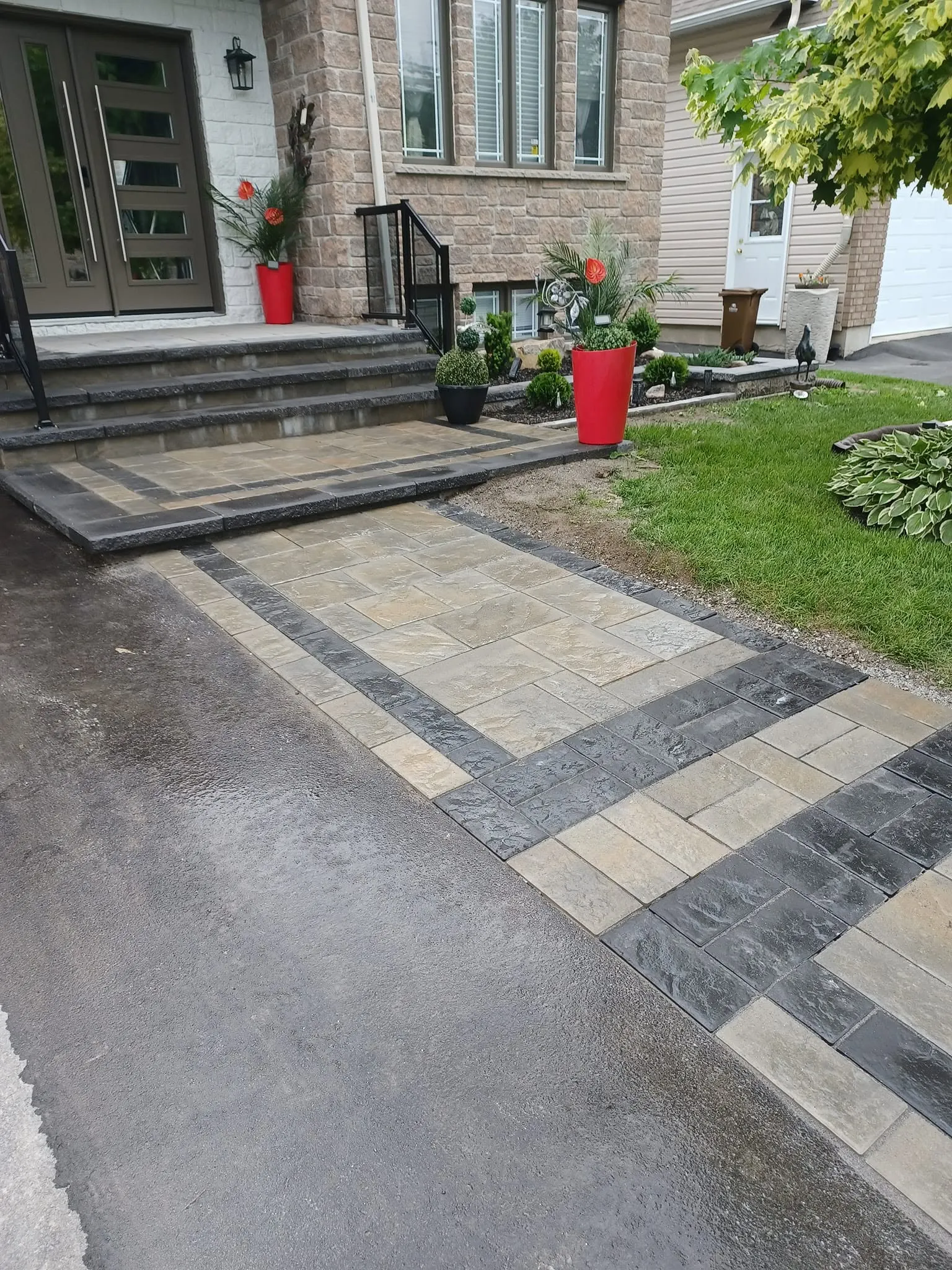 Entrée de pavé uni avec bordure à deux tons devant une résidence